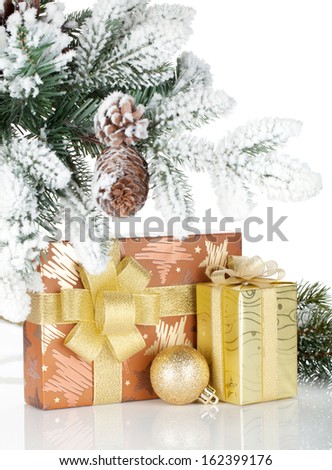 Gift box and christmas decor under snowy fir tree. Isolated on white background