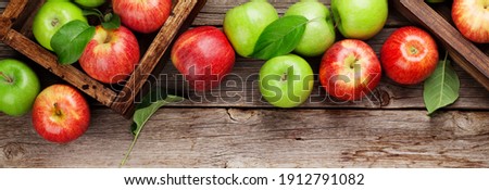 Ripe green and red apples in wooden boxes. Top view flat lay