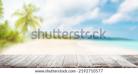Empty wooden table or pier with sunny beach and sea on background. With copy space for your product Foto d'archivio © 