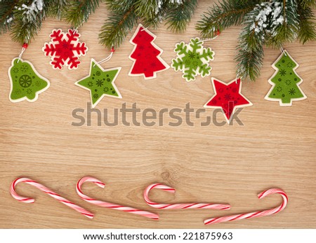 Christmas fir tree, candy cane and decor on wooden board with copy space