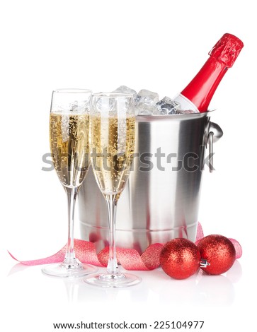 Champagne bottle in ice bucket, two glasses and christmas decor. Isolated on white background