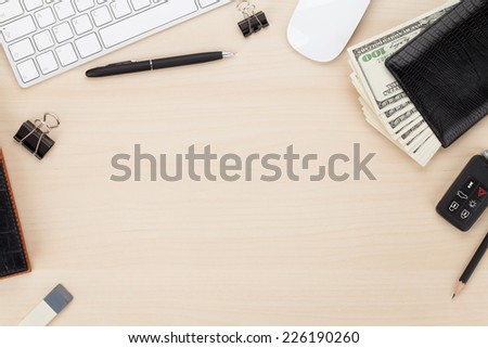 Office table with pc, supplies and money cash. View from above with copy space