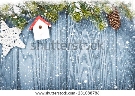 Christmas wooden background with snow fir tree, decor and copy space