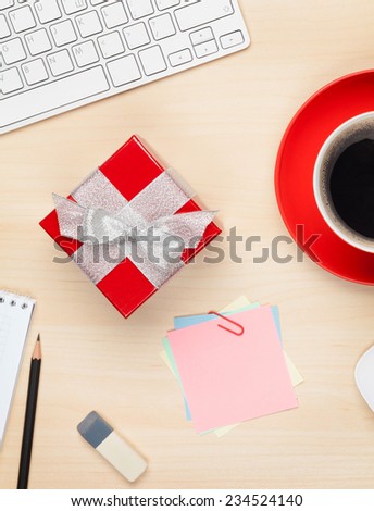 Red gift box on office table. View from above