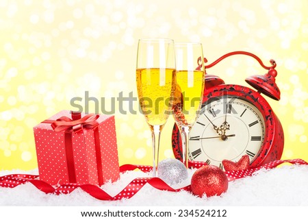 Champagne, gift box and christmas clock with bokeh background