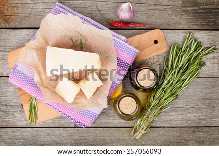 Parmesan cheese, herbs and spices on wooden table background