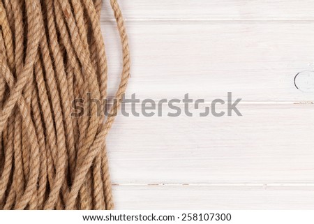 Wooden background with marine rope and copy space