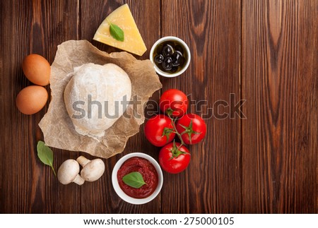Pizza cooking ingredients. Dough, vegetables and spices. Top view with copy space