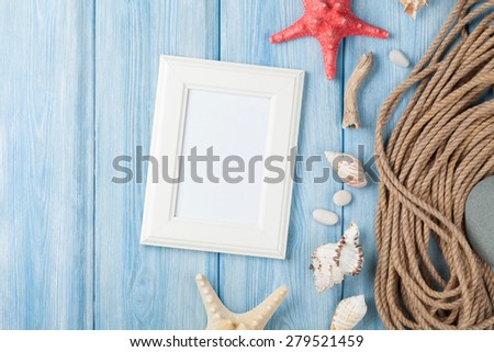 Summer time sea vacation with blank photo frame, star fish and marine rope