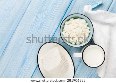 Dairy products on wooden table. Milk, cheese and curd cheese. Top view with copy space