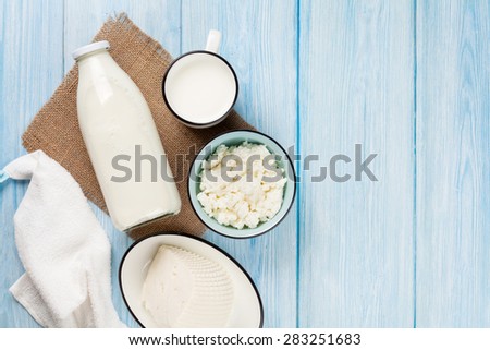 Dairy products on wooden table. Milk, cheese and curd. Top view with copy space