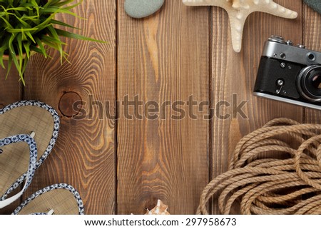 Travel and vacation items on wooden table. Top view with copy space