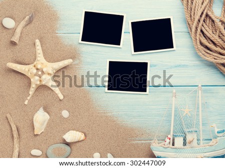 Travel and vacation photo frames and items on wooden table. Top view. Toned