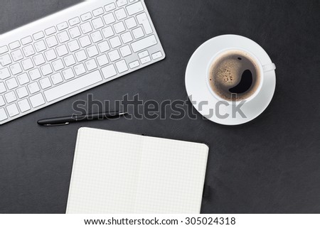 Office leather desk table with computer, supplies and coffee cup. Top view with copy space