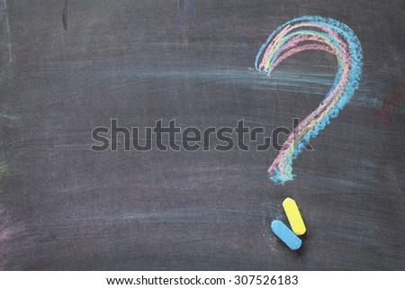 Colorful chalk question mark on blackboard background with copy space