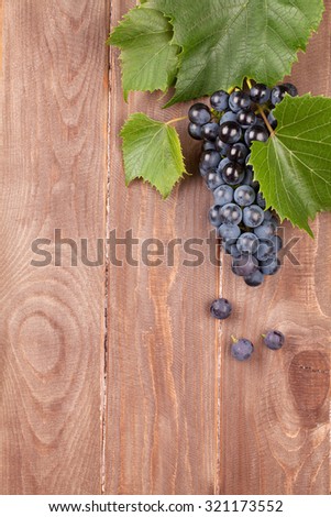 Red grape on wooden table. Top view with copy space