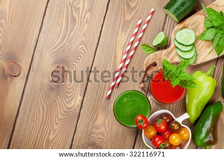 Fresh vegetable smoothie on wooden table. Tomato and cucumber. Top view with copy space