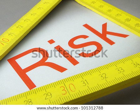 Risk and measure words\
\
A wooden ruler and measurement of the written word