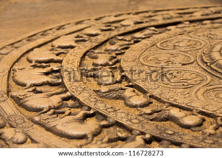 A ground carving at the entrance to the Vatadage is a moonstone relief depicting the cycle of sansara in the ruins of ancient capitol of Polonnaruwa, Sri Lanka. Side