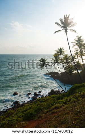 A beautiful high key tropical landscape of the ocean and rocky coastline from  a headland near the beach resort village of Mirissa, Sri Lanka