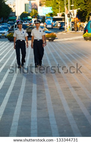 SEOUL, KOREA - AUGUST 28, 2009: Young Korean men patrol the downtown streets as civilian police, an alternative to mandatory military service in Seoul, South Korea on August 28, 2009