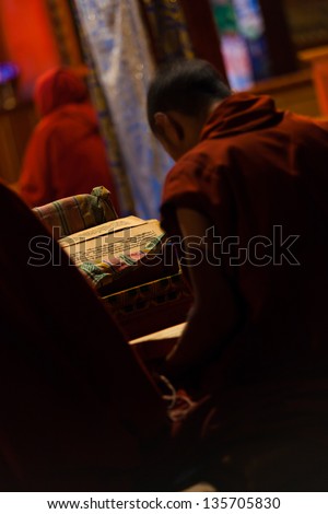 BOMI, CHINA - OCTOBER 15: An unidentified Tibetan boy studies buddhist texts in a monastery to be a monk, a waning tradition among young Tibetan boys in Tibet on October 15, 2007 in Bomi, China