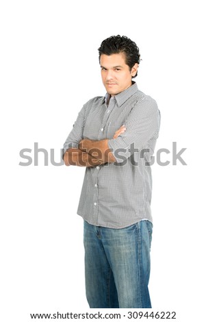 No nonsense hispanic male wearing casual clothes with chin tucked, arms crossed looking at camera expressing tough, reserved, stern, stubborn, disappointed, scolding attitude. Vertical