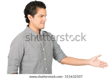 Hospitable, good looking hispanic man in casual button down shirt extending, offering handshake looking directly at camera, greeting warmly with a caring, friendly smile. Horizontal half-length