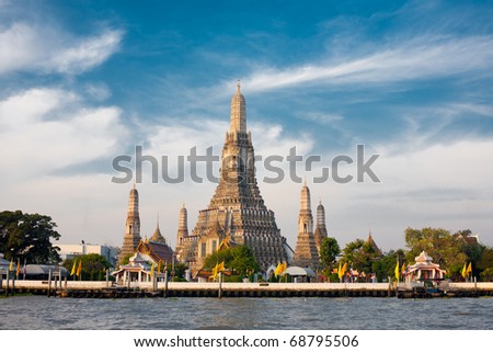 The Temple of Dawn, Wat Arun, on the Chao Phraya river and a beautiful blue sky in Bangkok, Thailand