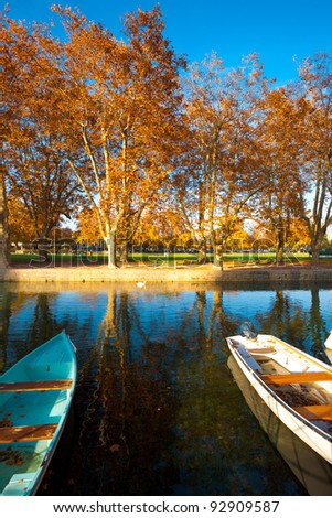 A tranquil pond and boats at a family park in Annecy, France