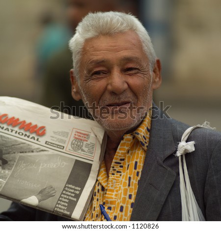 Close-up of a man holding up a newspaper, Havana, Cuba