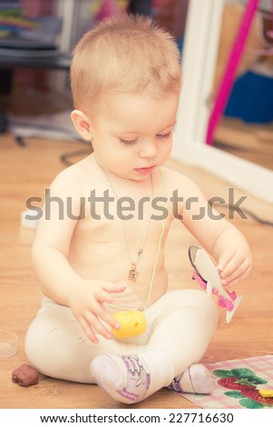 Top view of little boy playing on the floor