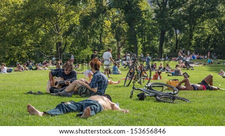 NEW YORK - SEPTEMBER 9: sunbathing in Central Park on September 9, 2013 in New York. Central Park is a public park at the center of Manhattan, which opened in 1857, on 778 acres of city-owned land.