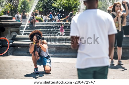 NEW YORK - JUNE 16: photographer in Washington Square Park on June 16, 2014 in New York. Washington Square Park is one of the best-known of New York City\'s 1,900 public parks.
