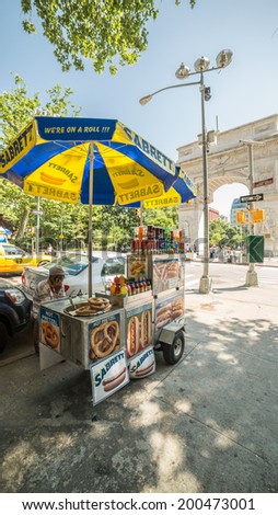 NEW YORK - JUNE 16: hot dog vendor by Washington Square Park on June 16, 2014 in New York. Washington Square Park is one of the best-known of New York City\'s 1,900 public parks.