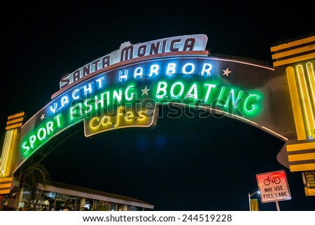 SANTA MONICA - JAN 14, 2015: Entrance Sign to Santa Monica Pier on Ocean Avenue in LA California at Night. Santa Monica is a beachfront city in Los Angeles California.