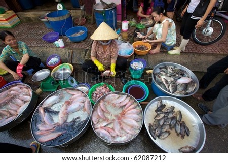 HO CHI MINH CITY, VIETNAM- CIRCA JUNE 2010: Street Vendor in Ho Chi Minh City, Vietnam selling fresh fish on the sidewalk (Ho Chi Minh City, Vietnam - CIRCA June, 2010)
