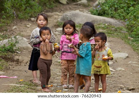 SAPA, VIETNAM - NOVEMBER 21: Six unidentified Vietnamese children play and eat in Sapa, Vietnam on November 21, 2010. Vietnam\'s 2011 population is 90,549,390 with 25% of the population age 14 and under