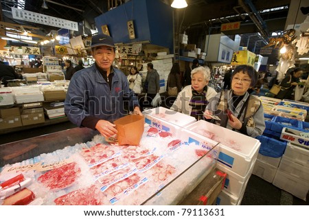 TOKYO- NOVEMBER 20: Seafood buyers at the Tsukiji Wholesale Seafood and Fish Market in Tokyo Japan on November 20, 2009.  Tsukiji Market is the biggest wholesale fish and seafood market in the world.