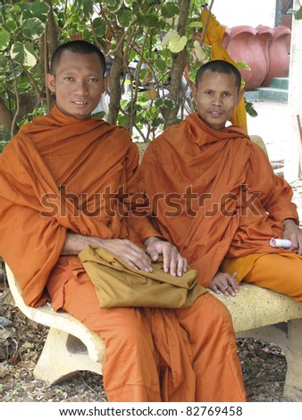 SIEM REAP, CAMBODIA- APRIL 1: Two unidentified Buddhist monks sitting in Siem Reap on April 1, 2011. Buddhism is currently estimated to be the faith of 96% of the Cambodian population.