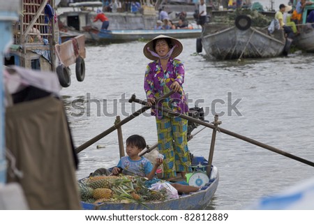 CAN THO, VIETNAM- MAY 28: Unidentified Vietnamese woman and child at Cai Rang Floating Market in Can Tho, Vietnam on May 28, 2011. Cai Rang Market is the biggest floating market in the Mekong Delta