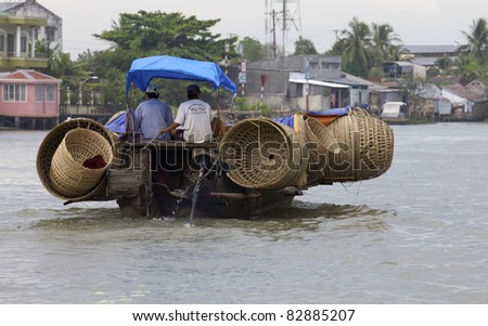 CAN THO, VIETNAM - MAY 28: A boat with baskets heading to market at Cai Rang Floating Market in Can Tho, Vietnam on May 28, 2011. Cai Rang Market is the biggest floating market in the Mekong Delta