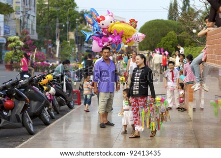 CAN THO, VIETNAM-JAN 6: Vietnamese street vendors selling balloons and toys in Can Tho, Vietnam on January 6, 2012. Vietnam\'s 2011 population is 90,549,390 with 25% of the population age 14 and under