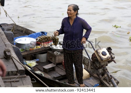 CAN THO, VIETNAM-JAN 7: Vietnamese woman selling fresh food from boat at the Floating Market in Can Tho, Vietnam on January 7, 2012. Can Tho Market is the biggest floating market in the Mekong Delta