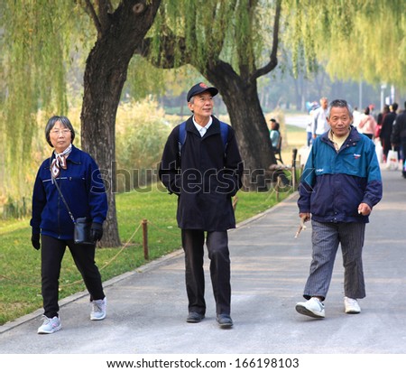 BEIJING - OCT 27: People take a walk on Oct 27,2013 in Beijing, China.  China will have an ageing population from 2035, when one elderly person needing to be supported for every three workers or fewer