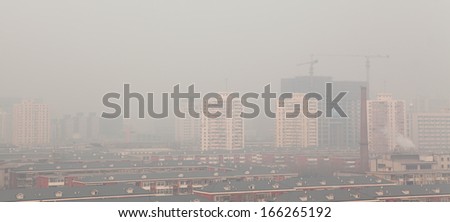 BEIJING - DEC 7: Beijing skyline and smog on Dec 7, 2013 in Beijing, China.  The pollution was recorded in central and eastern regions of the country at orange level which is called \