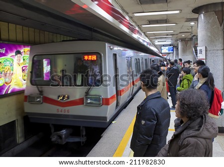 BEIJING, CHINA - JAN. 12, 2014: Crowded subway train. Any subway trip, costs only 2 yuan (33 US cents); Beijing government\'s  plans to reform the current low-cost subway ticket system