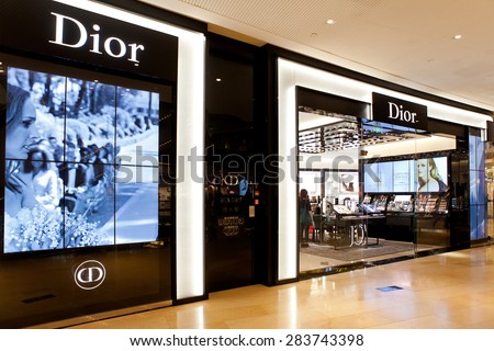 GUANGZHOU, CHINA-FEB. 23, 2015: A woman is seen at a Dior store; Dior is a French luxury goods company founded in 1946, its products are sold at its retail stores worldwide, and by its online store.