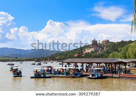 BEIJING, CHINA-AUG.22, 2015: People enjoy boating under a blue sky on the Kunming Lake at the Summer Palace. The Summer Palace is a popular tourist destination that covers an area of 2.9 km2.