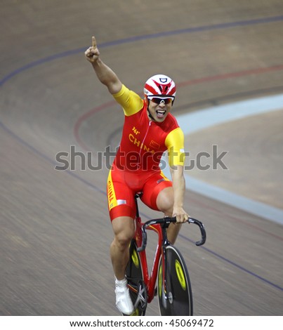 BEIJING  - JANUARY 22: A member of the China\'s team celebrates winning Gold medal in Men\'s Team Sprint final in the UCI World Cup Classics cycling event on January 22, 2010 in Beijing, China.